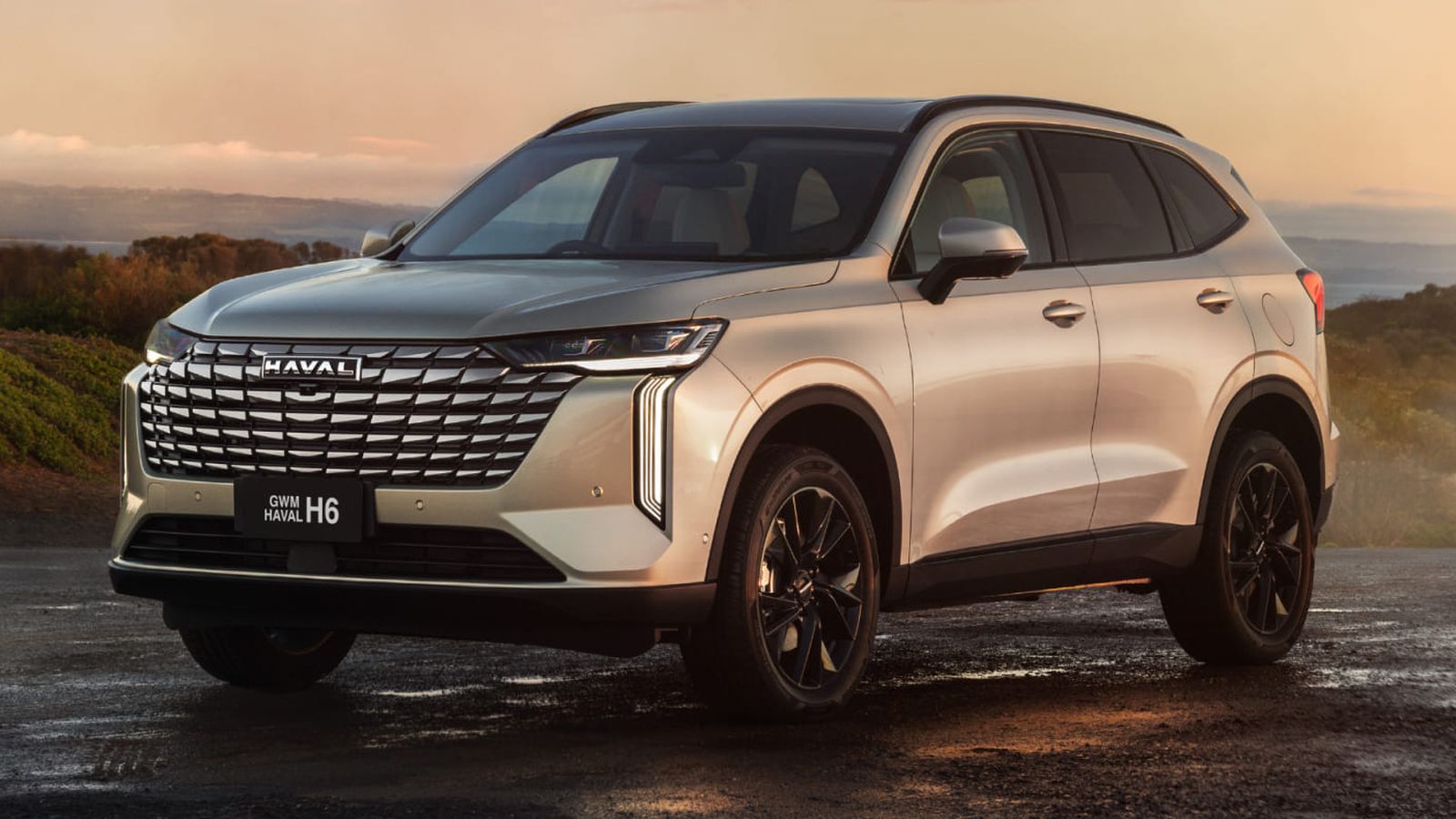GWM Haval H6 SUV in champagne at sunset on a coastal road